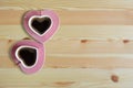 Black coffee in two pink cups heart shape on wooden floor, Copy space or empty space for text