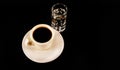 Black coffee in the white cup and a glass of sambuca with coffee Royalty Free Stock Photo