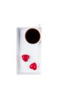 Black coffee in a white cup and two red hearts candy isolated on white background. Happy Valentine`s Day Royalty Free Stock Photo