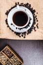 Black coffee in white cup on wood background.
