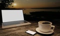 Black coffee in white cup on wooden surface table. Blur blank screen labtop , Black smartphone  white screen  on table. Copy space Royalty Free Stock Photo