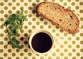 Breakfast with a black coffee, bread and some greens Royalty Free Stock Photo