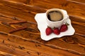 Black coffee in whute cup with strawberry, cinnamon and spices Royalty Free Stock Photo