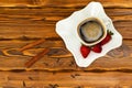 Black coffee in whute cup with strawberry, cinnamon and spices on a wooden red table Royalty Free Stock Photo