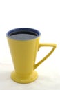 Black coffee in yellow triangular cup