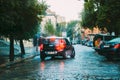 Black Color Car Mini Cooper Countryman Goes In The Rain On The Street Of The European City. Royalty Free Stock Photo