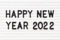Black letter in word happy new year 2022 on white felt board background