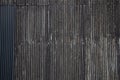Black color old rusty wavy metal plate wall