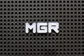 Black pegboard with white letter in word mgr abbreviation of manager Royalty Free Stock Photo