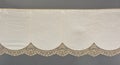 Color straight strip of lace fabric on a gray background. Elastic silk nylon braid border. use for clothes and linen decoration Royalty Free Stock Photo