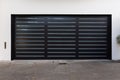 A black color two car garage door with slim horizontal lines Royalty Free Stock Photo