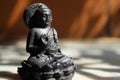 Black colored famous religious leader `Gautama Buddha` decoration piece display under daylight. Royalty Free Stock Photo