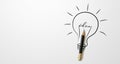 Black colour pencil with outline light bulb and word idea on white paper background Royalty Free Stock Photo