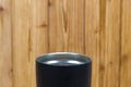 Black colour stainless steel tumbler or cold and hot storage cup on wood Royalty Free Stock Photo