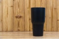 Black colour stainless steel tumbler or cold and hot storage cup on wood Royalty Free Stock Photo