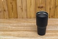 Black colour stainless steel tumbler or cold and hot storage cup on wood Royalty Free Stock Photo