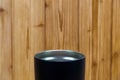 Black colour stainless steel tumbler or cold and hot storage cup on wood Royalty Free Stock Photo