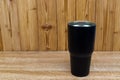 Black colour stainless steel tumbler or cold and hot storage cup on wood Royalty Free Stock Photo