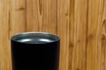 Black colour stainless steel tumbler or cold and hot storage cup on wood Royalty Free Stock Photo