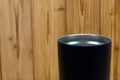 Black colour stainless steel tumbler or cold and hot storage cup on wood Royalty Free Stock Photo