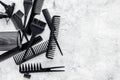 Black combs, brushes for hairdresser work on stone desk background top view mock up