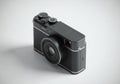 A black, compact digital camera with a sleek design. It features a large lens at the front, Royalty Free Stock Photo