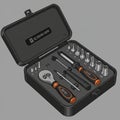 A black, compact tool case containing a ratchet wrench, several screwdriver bits, and Royalty Free Stock Photo