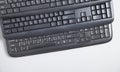 Black computer keyboards on grey background