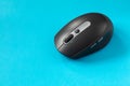Black computer mouse on blue background. Wireless optical PC mouse. Wireless technology Royalty Free Stock Photo