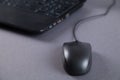 Black computer and mouse on gray table with empty screen Royalty Free Stock Photo