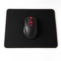 Black computer mouse on a matching mousepad with red accents Royalty Free Stock Photo