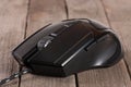 Black computer mouse on the old wooden background close-up Royalty Free Stock Photo