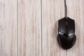 Black computer mouse on a white wooden background with copy space for your text. Top view Royalty Free Stock Photo