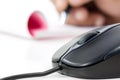 Black computer mouse and writing pad Royalty Free Stock Photo