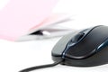 Black computer mouse and writing pad Royalty Free Stock Photo