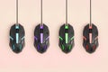 Black computer mouses hang on pastel peach background