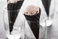 Black cone, waffle cup with ice cream, ice cream in a black cone and glass.