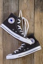 Black Converse sneakers shoes on wood