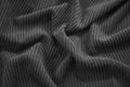 Black corduroy with soft wavy creases background. Durable fabric.