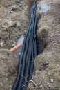 Black corrugated plastic drainage pipes laying in a ditch at a construction site Royalty Free Stock Photo