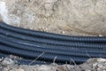 Black corrugated plastic drainage pipes laying in a ditch at a construction site Royalty Free Stock Photo