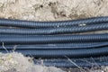 Black corrugated plastic drainage pipes laying in a ditch at a construction site Royalty Free Stock Photo