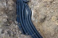 Black corrugated plastic drainage pipes laying in a ditch at a construction site Royalty Free Stock Photo