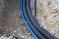 Black corrugated plastic drainage pipes laying in a ditch at a construction site Royalty Free Stock Photo