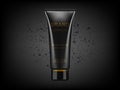 Black cosmetic plastic tube with charcoal powder explosion on black background. Charcoal detox cream or face mask, cosmetic