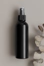 Black cosmetic spray bottle mockup with an eucalyptus on the beige background Royalty Free Stock Photo