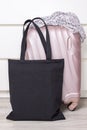 Black cotton eco tote bag with a travel suitcase, design mockup. Handmade shopping bags Royalty Free Stock Photo