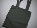 Black cotton textile bag on a gray floor