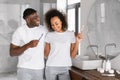 black couple brushing teeth in morning in modern bathroom indoors Royalty Free Stock Photo