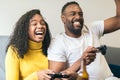 Black couple enjoying playing video game at home. laughing and smiling. winner celebration Royalty Free Stock Photo